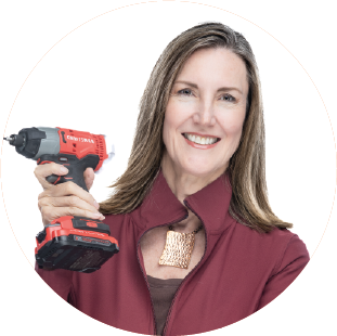 Laura Hansen holding a power drill.